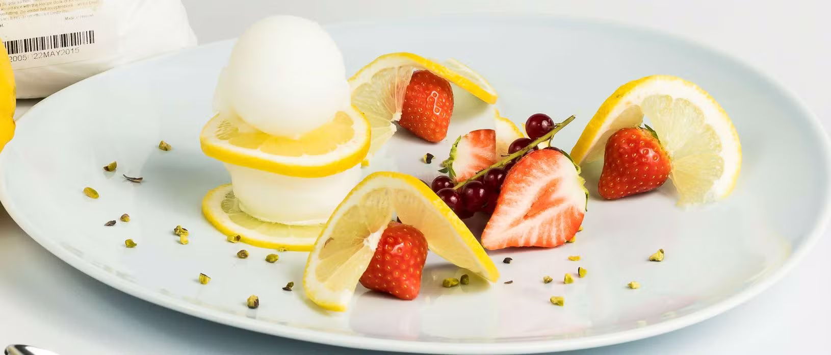 Ice cream and fruits on a plate.